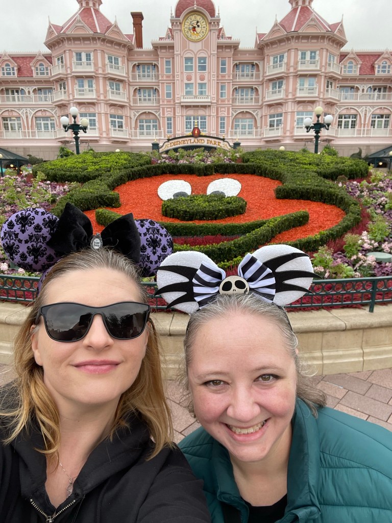 Two white women with blond complexions wearing Micky Mouse ears and ready for a day of Disney magic.