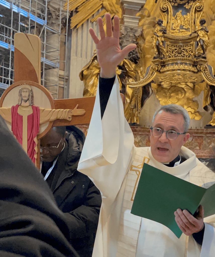Priest blessing pilgrims at St. Peter's Basilica. 